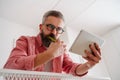 Man using smart thermostat while brushing teeth in bathroom. Concept of sustainable, efficient, and smart technology in Royalty Free Stock Photo