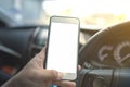 A man is using a smartphone in a car on the highway. The concept of using Internet technology for online conversations. and