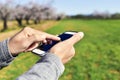 Man using a smartphone in a natural landscape