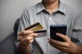 Man using smartphone for online banking or shopping and payment via credit card. man paying and shopping with mobile phone Royalty Free Stock Photo