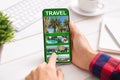 Man Using Smartphone With Online Travel App In Office, Exploring Future Destinations