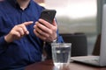 Man using smartphone at table in cafe, closeup Royalty Free Stock Photo