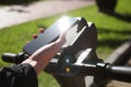 Man using smartphone to pay and unblock rental electric scooter outdoors, closeup