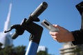 Man using smartphone to pay and unblock rental electric scooter outdoors, closeup