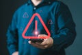 Man using smartphone with warning sign.Notification error and virus detection spyware. Emergency warning alert alarm on smartphone Royalty Free Stock Photo