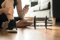 Man using smartphone during workout at home