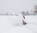 Man using snow blower on snowy drive Royalty Free Stock Photo