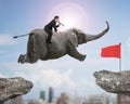 Man with using speaker riding elephant flying toward red flag Royalty Free Stock Photo