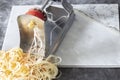 Man using spiralizer to cut apple into strips.