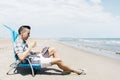 Man using a tablet on the beach Royalty Free Stock Photo