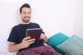 Man using tablet on bed. Royalty Free Stock Photo