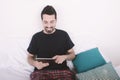 Man using tablet on bed. Royalty Free Stock Photo