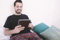 Man using tablet on bed. Royalty Free Stock Photo