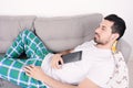 Man using tablet on couch. Royalty Free Stock Photo