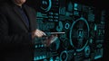 Man Using Tablet with Futuristic AI Data Visualizations in a High-Tech Environment Overlaid with Graphs and Icons Cipher Royalty Free Stock Photo