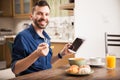 Man using a tablet over breakfast Royalty Free Stock Photo