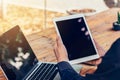 Man using tablet on table in coffee shop with vintage toned filter. Royalty Free Stock Photo