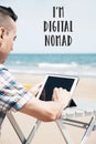 Man using a tablet and text I am digital nomad Royalty Free Stock Photo