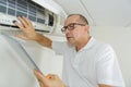 Man using tablet to adjust air conditioning system Royalty Free Stock Photo
