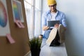 Man using Tablet for Work and Browsing Information, Young creative manager sitting by the window. Royalty Free Stock Photo