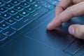 Man using touchpad on notebook keyboard with his finger Royalty Free Stock Photo