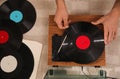 Man using turntable at home, top view