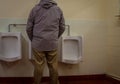 Man using the urinal Royalty Free Stock Photo