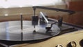 Man using a Vintage record player with vinyl disc close up