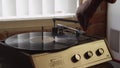 Man using a Vintage record player with vinyl disc close up