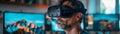 Man using a virtual reality headset in a modern room with multiple screens displaying vibrant visuals in the background