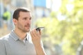 Man using voice recognition on phone in the street