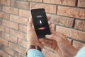 Man using voice search on smartphone near wall, closeup