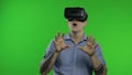 Man using VR headset helmet to play game. Watching virtual reality 3d 360 video. Chroma key Royalty Free Stock Photo