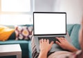 Man using, working on laptop with blank screen while lying on sofa in living room Royalty Free Stock Photo