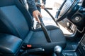 Man vacuuming, hoovering a car interior by vacuum cleaner, cleaning concept Royalty Free Stock Photo