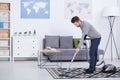 Man vacuuming in a living room