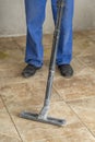 the man vacuums the tile after laying. preparation for jointing