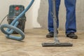 the man vacuums the tile after laying. preparation for jointing