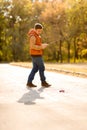 Man in vest playing with toy car on remote control in autumn Park Royalty Free Stock Photo