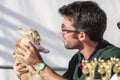 Man veterinarian examines a bunny holding in his hands