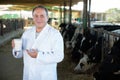 Man veterinarian with milk on dairy farm Royalty Free Stock Photo