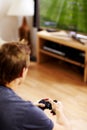 Man, video game and home with tv, controller or back to relax with online competition in living room. Gamer person