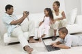 Man Videotaping Family sitting on sofa Royalty Free Stock Photo