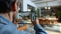 Man Viewing Open Concept Kitchen on Tablet