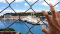 Man views yachts behind fence, corrupt official looks at confiscated property