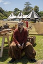 Man In Viking Costume Beside Replica Display At Country Fair