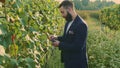 Man on vineyard with refractometer