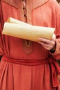 A man in vintage medieval clothes with a paper letter in his hand. Reco Royalty Free Stock Photo
