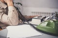 Man in vintage office uses green rotary telephone