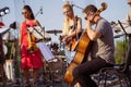 Male musician playing cello in orchestra at outdoor concert